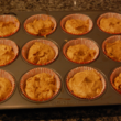 Scoop the mixture into a greased or lined muffin tin. Scoop the mixture into a greased or lined muffin tin.